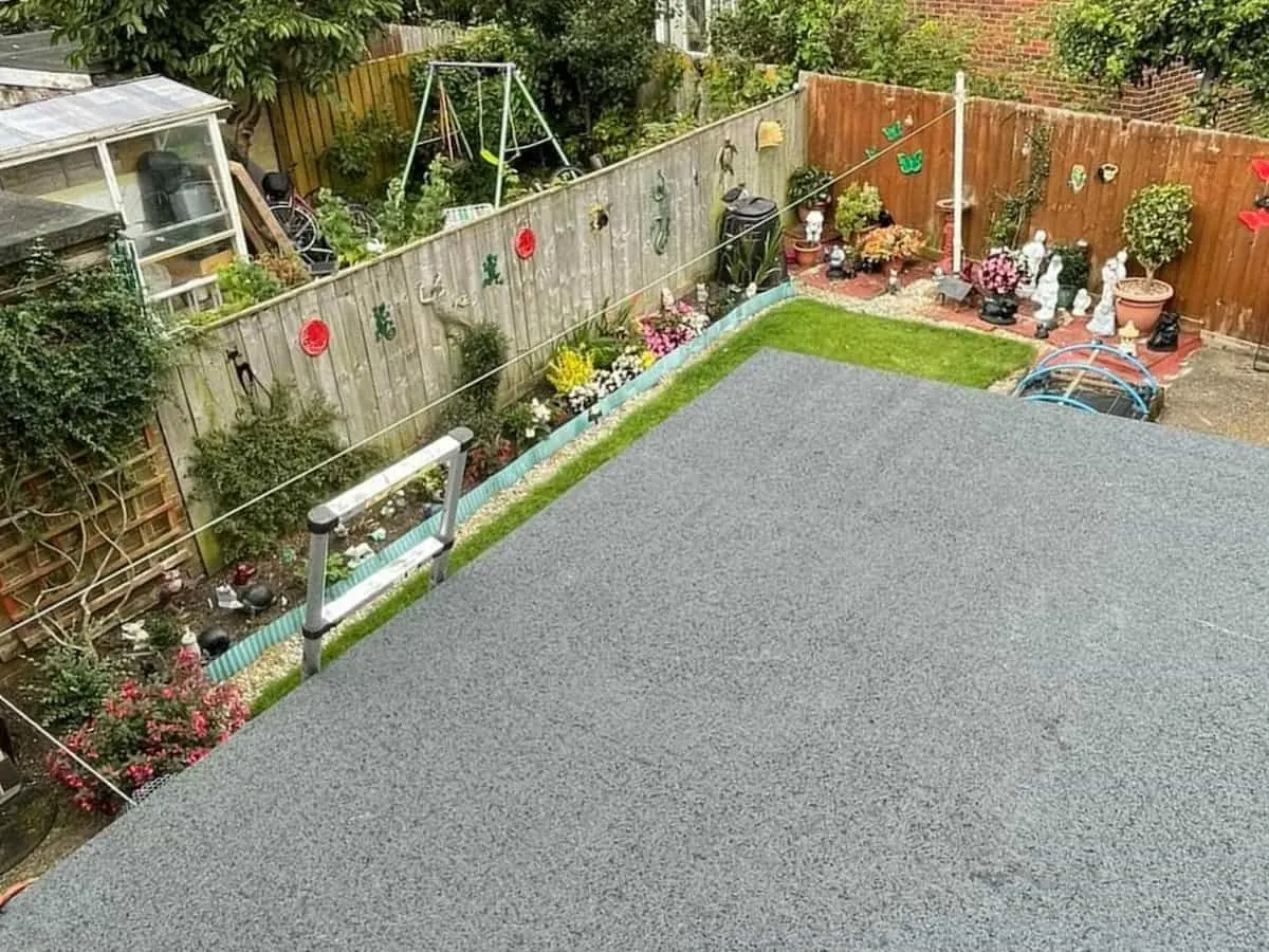 Grey felt flat roof over a garden extension