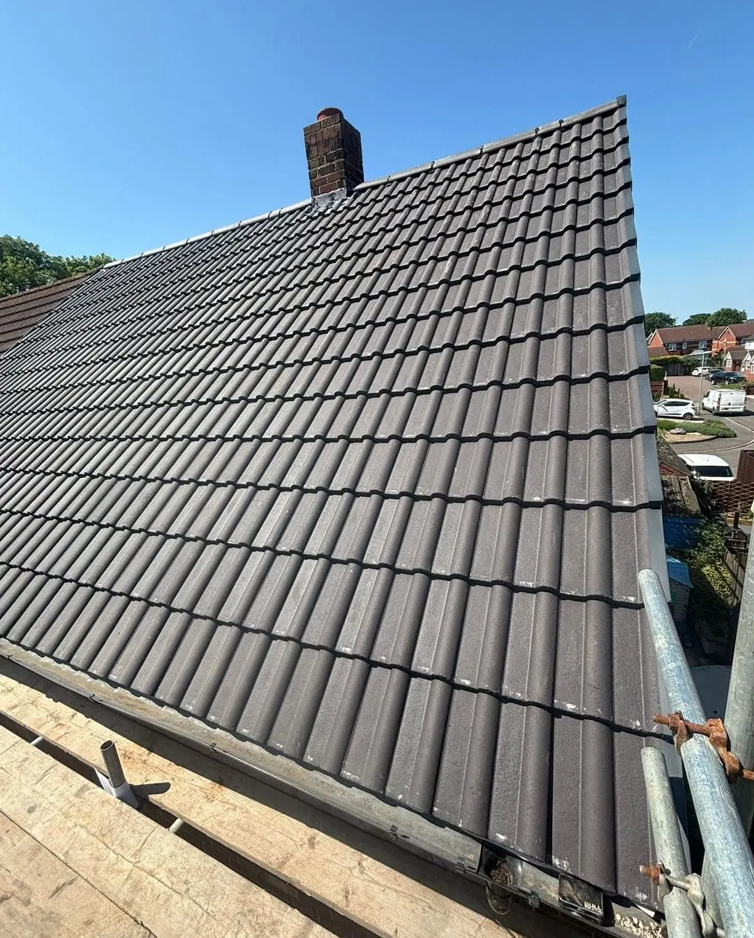 Grey tiled roof finished from the scaffold