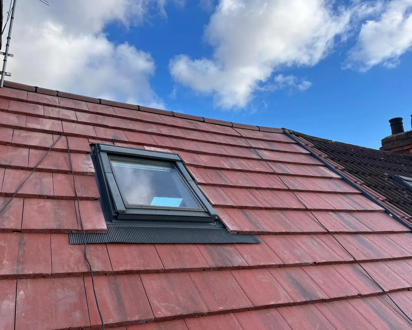 Roof window fitted in a red tiled roof