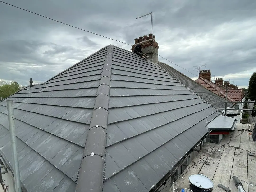 Grey tiled roof with a hip end