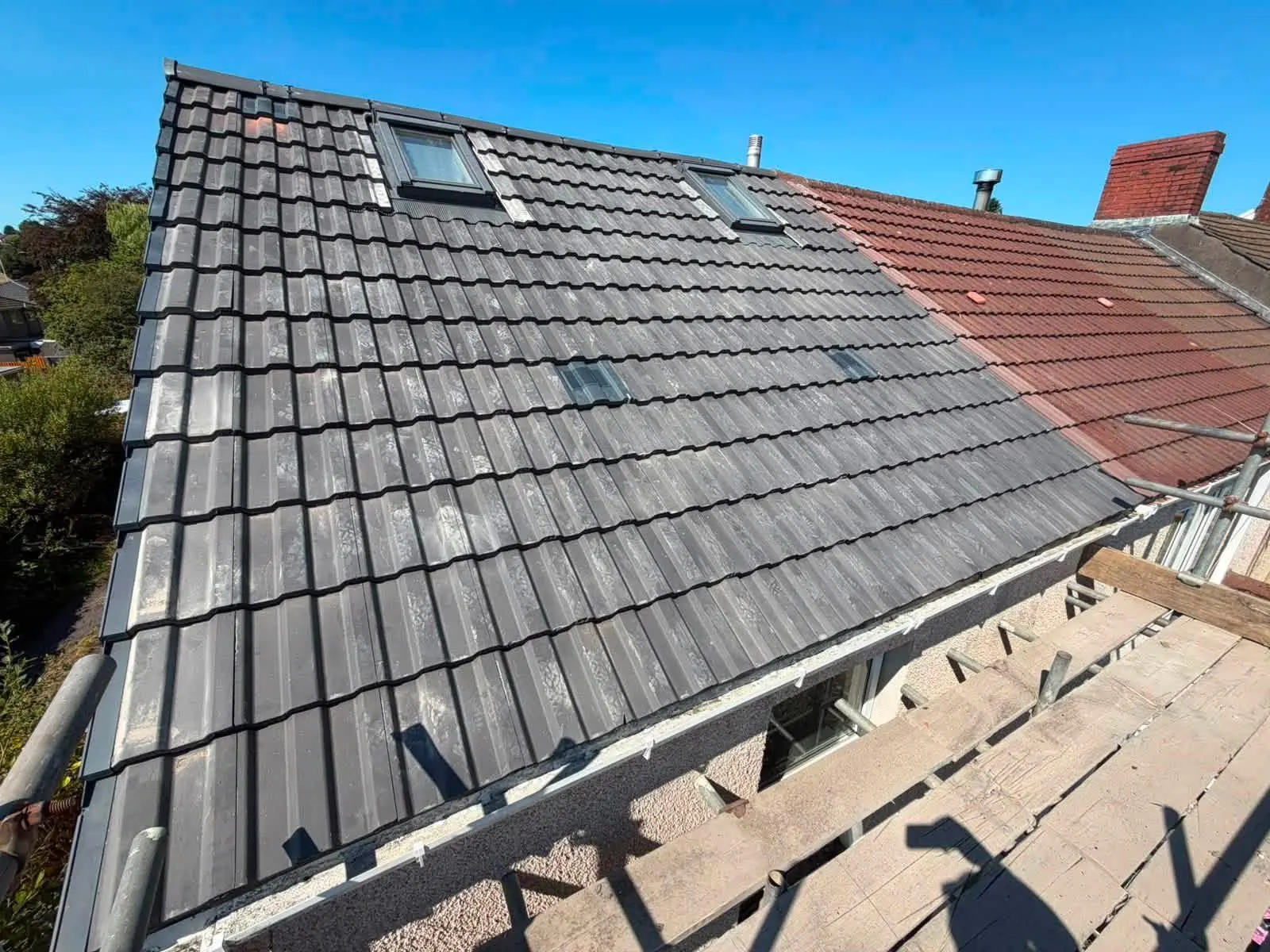 Grey tiled re roof with new roof windows