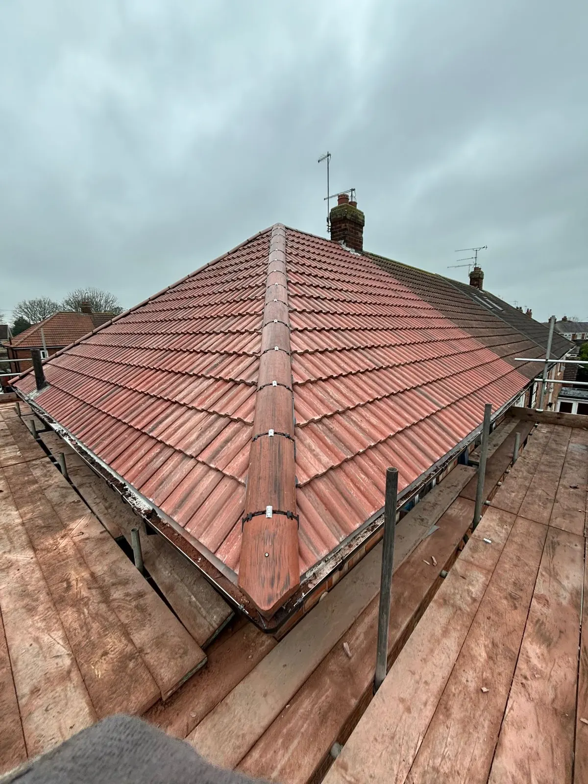Red tiled hipped roof after re roofing
