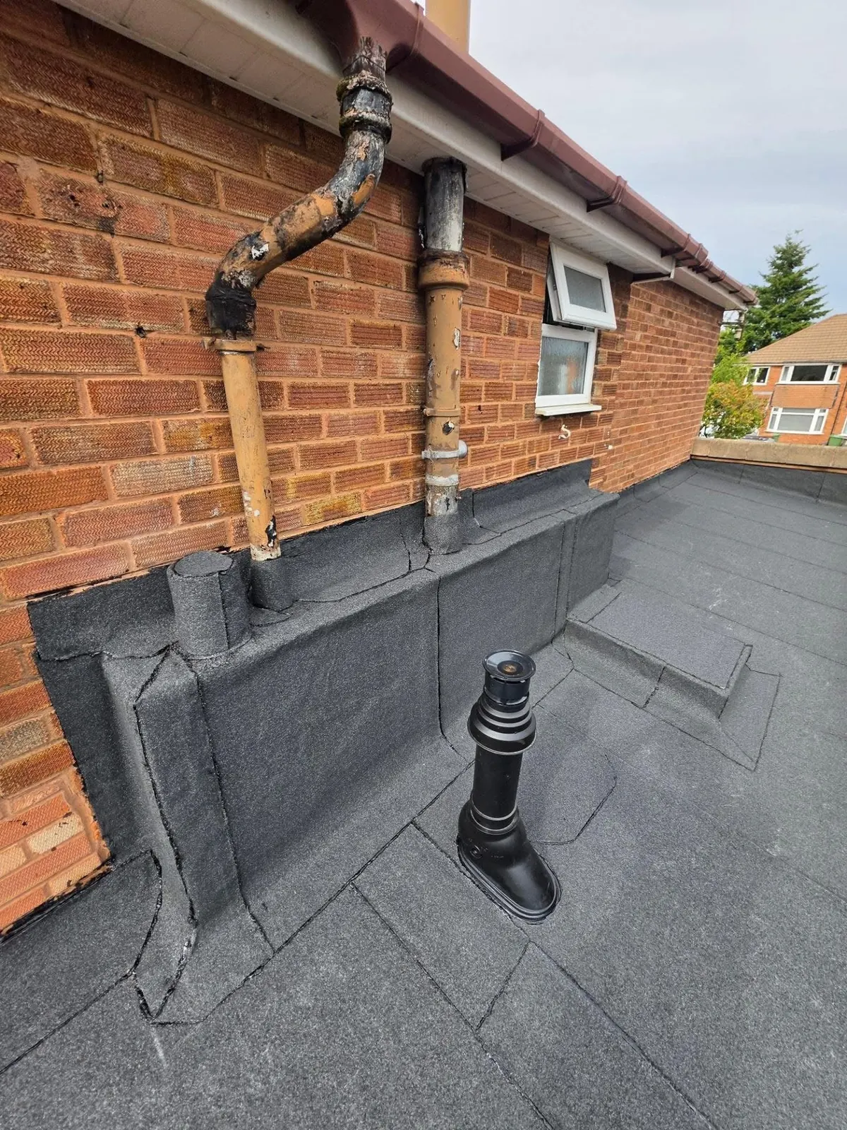 Felt flat roof with a new upstand and vent