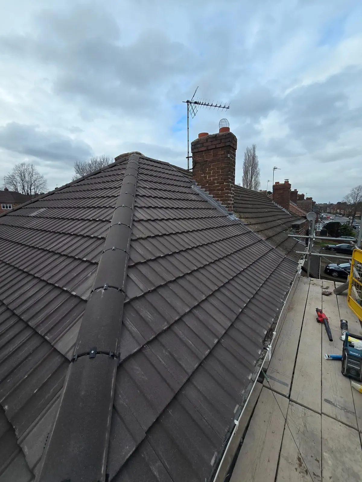 Grey tiled roof with a hip end