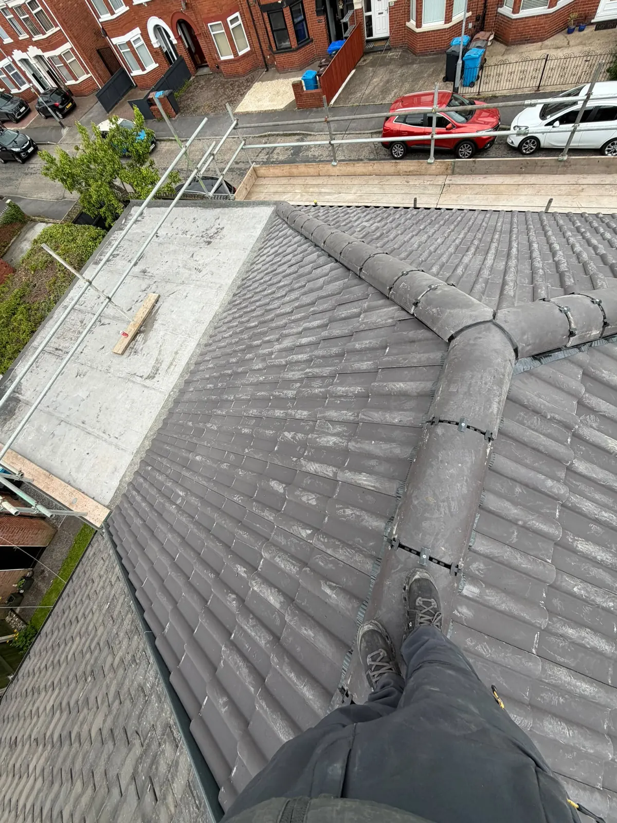 Grey tiled roof with a new ridge