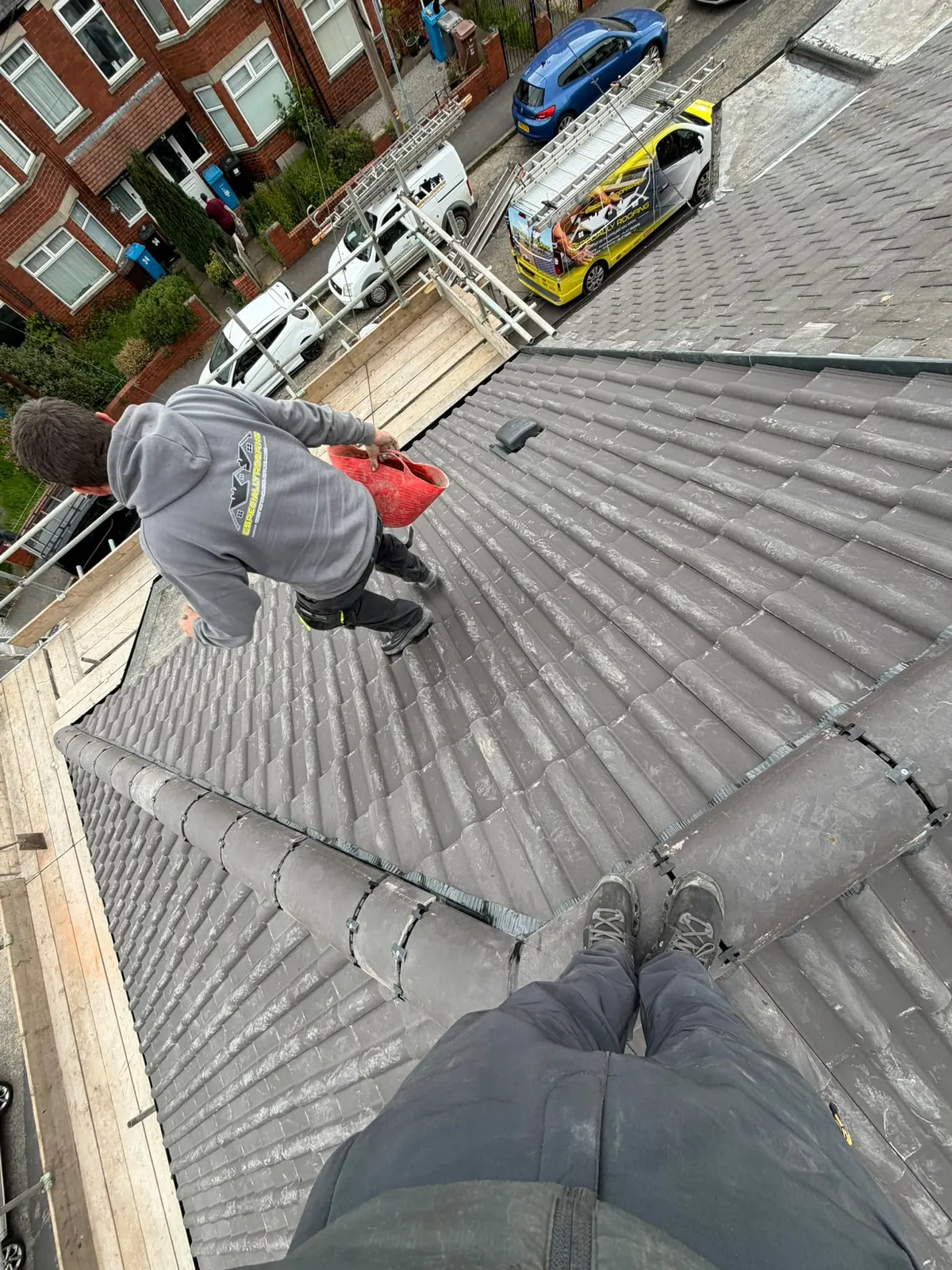 Roofer working on a grey tiled roof