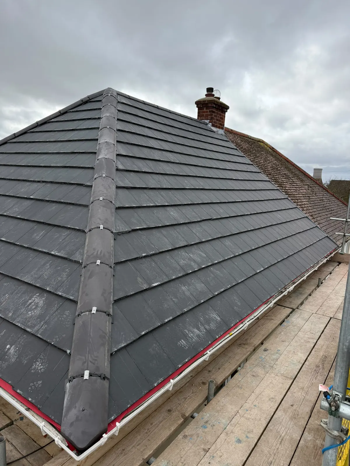 Grey tiled hipped roof complete