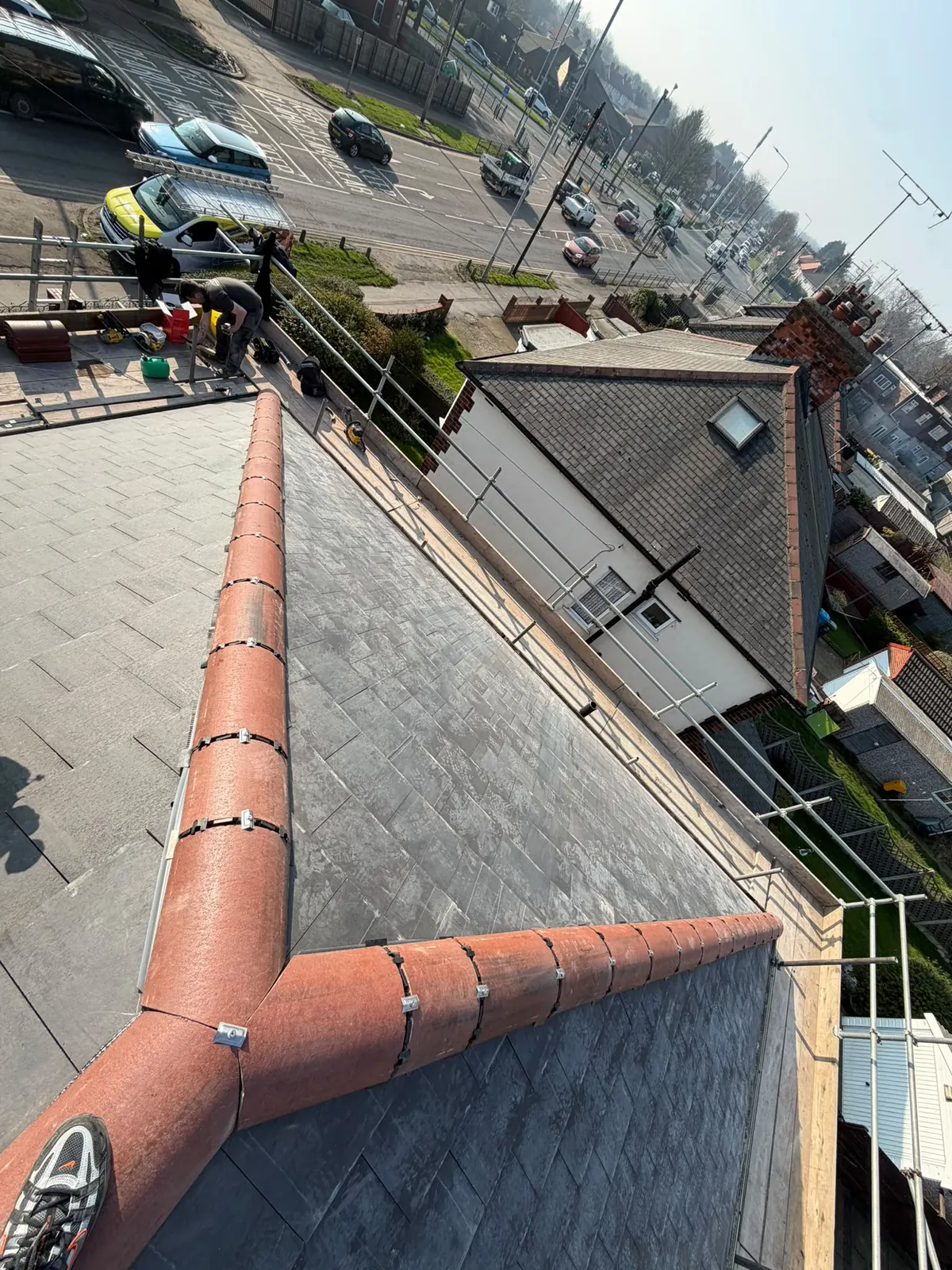 Red ridge tiles on a grey roof