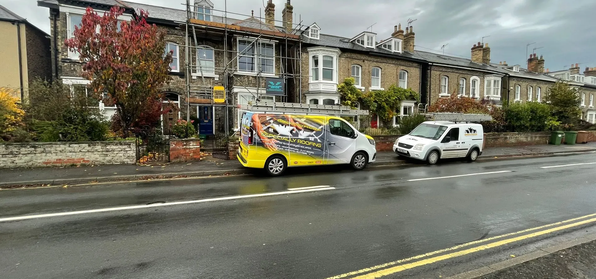 Especially Roofing vans parked on a Hull street beside a roofing job