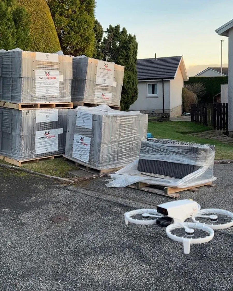 Especially Roofing inspection drone beside pallets of new roof tiles