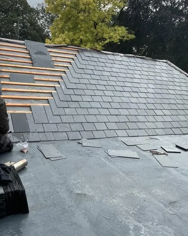 New slates going on around a roof window