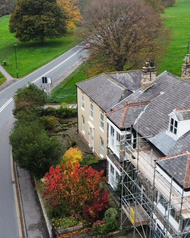 Drone view of a large house with scaffolding