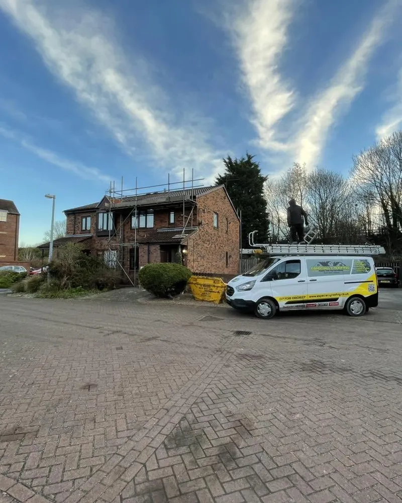Especially Roofing van parked at a job under a blue sky