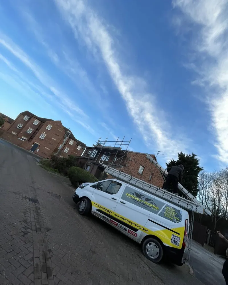 Especially Roofing van beside a block of flats